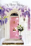 A welcoming Hendon doorway is bathed in soft light, with a pale pink front door acting as the serene focal point beneath a cascading canopy of lavender wisteria. The wisteria drapes in loose, tumbling garlands from above, each cluster of blooms a subtle blend of lilac and soft purple, casting delicate shadows over the whitewashed façade. To one side, a gently painted shutter in a similar blush tone balances the composition, hinting at the characterful homes dotted between Hendon's side streets and green pockets like Hendon Park. Just in front of the door, positioned as though freshly delivered, stands a vintage-style grey bucket overflowing with creamy white roses. The roses are fully open and plush, with layers of velvety petals that seem to glow against the muted metal of the container. Interwoven among them are slender sprigs of green foliage, providing a natural softness and a hint of woodland freshness. Around the bucket's base, a soft pink ribbon is tied in a graceful bow, its subtle sheen mirroring the pastel tones of the doorway and pulling the entire scene together. The lighting feels warm yet gentle, as if taken in late afternoon when the day's busyness is fading and the stillness of a new home begins to settle. Everything in the image-flowers, paintwork, vines, and shadow-works together to communicate a tender sense of welcome. It feels like a housewarming bouquet waiting patiently at the threshold, ready to greet its owners with comfort, optimism, and the quiet assurance that this Hendon address is the start of something beautiful.